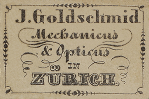 Eine alte Visitenkarte mit der Aufschrift "J. Goldschmidt Mechanicus & Optics in Zürich" aus dem frühen 20. Jahrhundert.