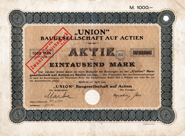 Ein alter deutscher Geldschein mit einem roten Stempel und Text, der darauf hinweist, dass es ein Aktienzertifikat ist.