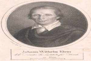Schwarz-weiß-Porträt von Johann Wilhelm Klein, Direktor des Instituts für Blinde in Wien, der einen weißen Hemd trägt und einen ernsten Gesichtsausdruck hat, mit deutschem Text unten.